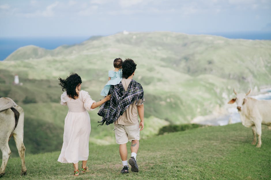 A family enjoys a peaceful walk with cattle in the rolling hills of Cagayan Valley, Philippines.
